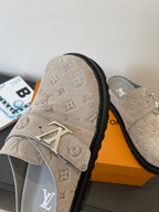 Louis Vuitton monogram slide sandals, front view of beige strap with LV emblem