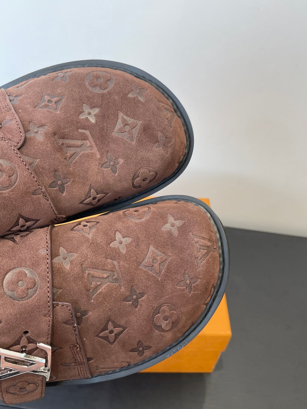 Brown monogram slip-on sandals, close-up of stitched toe and interior lining