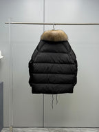 Long black puffer jacket back view on hanger with tan fur hood trim