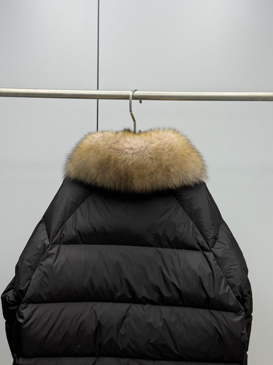 Long black puffer jacket back with tan fur hood trim