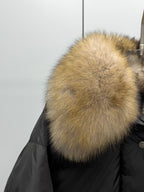 Tan fur collar on black puffer jacket with buttoned front placket