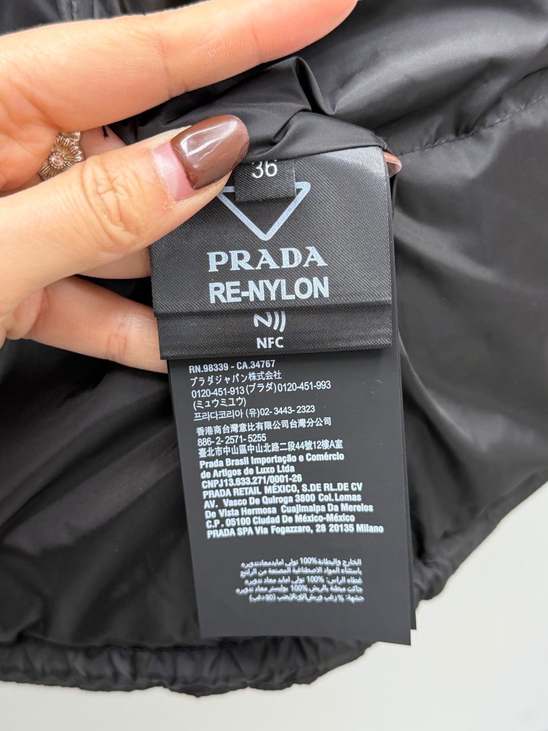 PRADA RE-NYLON size 36 care label on black puffer jacket