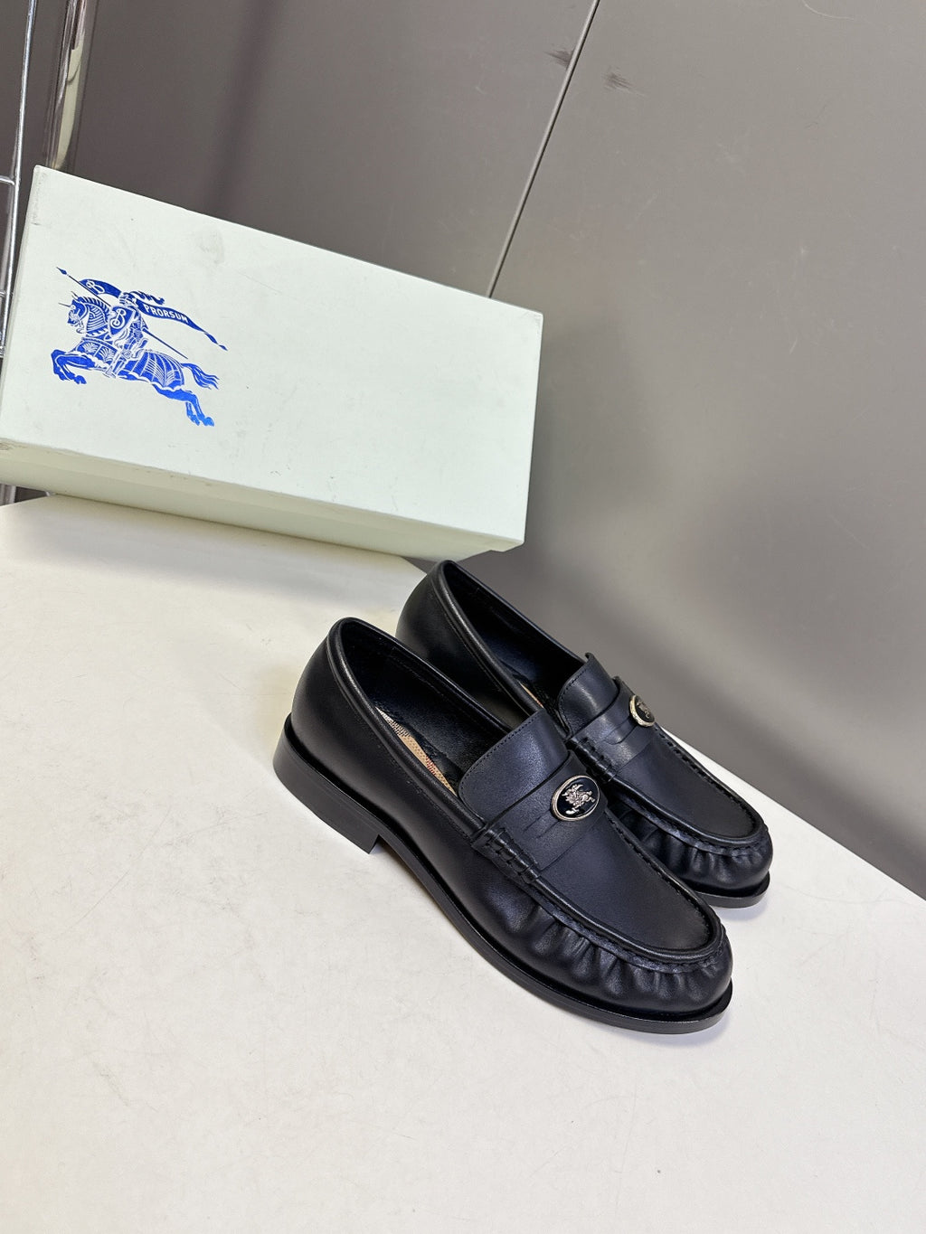 Burberry black leather loafer with slip-on apron stitching and logo hardware