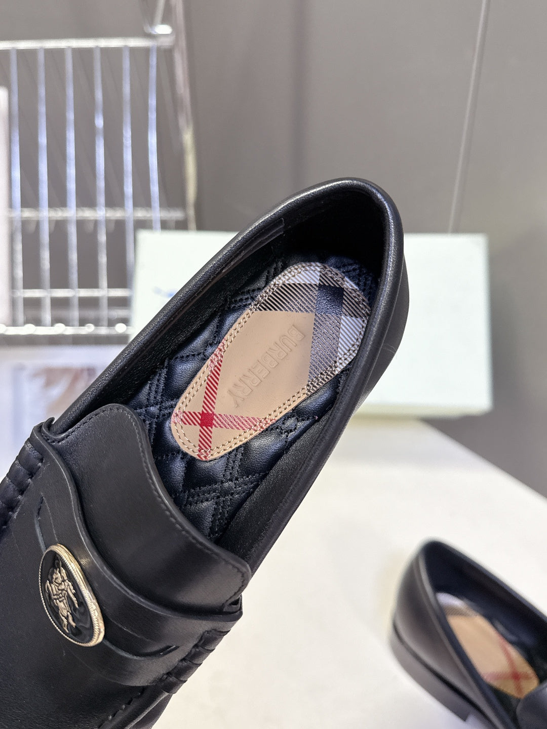 Burberry black leather loafer interior with plaid lining and logo insole