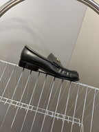 Burberry black leather loafer side profile with apron seam and low heel