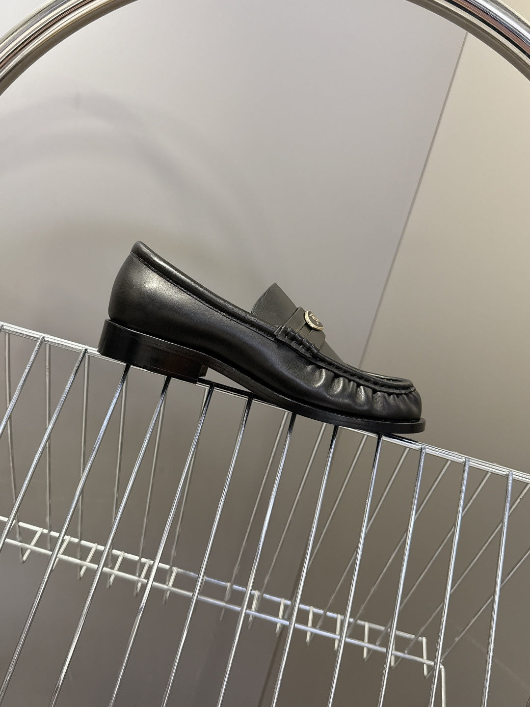 Burberry black leather loafer side profile with apron seam and low heel