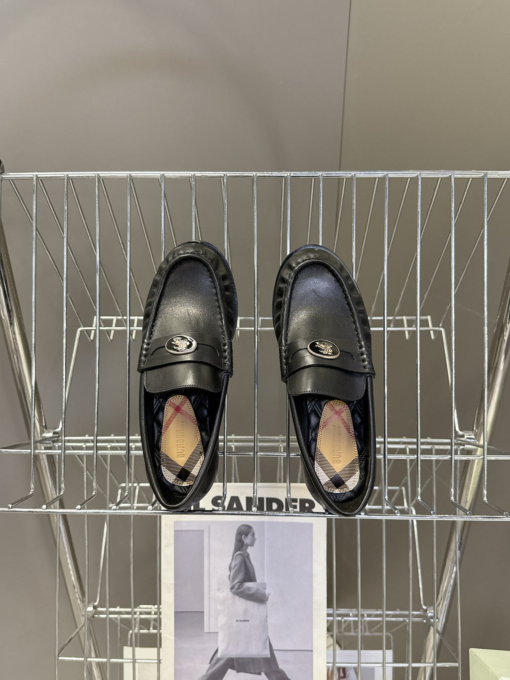 Burberry black leather loafers with logo strap and patterned interior lining