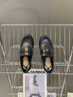 Burberry black leather loafers with logo strap and patterned interior lining