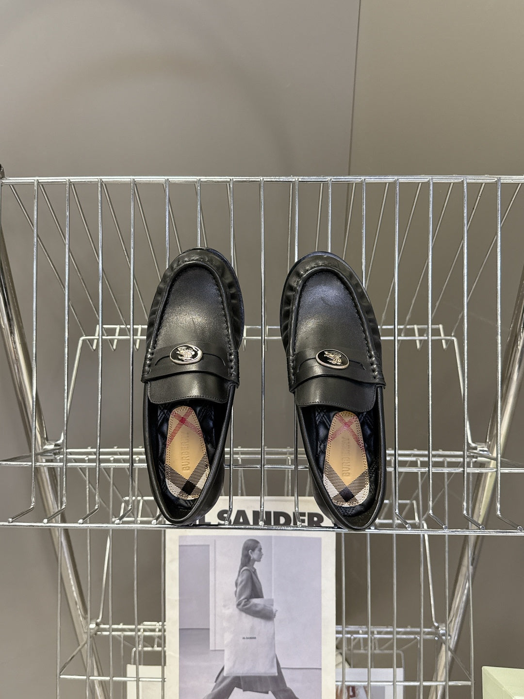 Burberry black leather loafers with logo strap and patterned interior lining