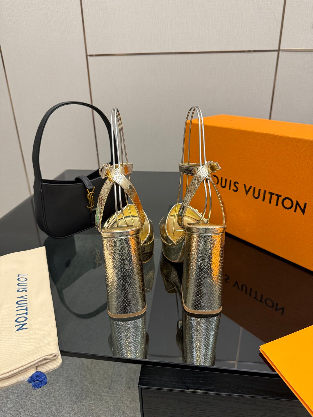 Louis Vuitton ladies metallic platform heeled sandals, angled view with buckle T-strap
