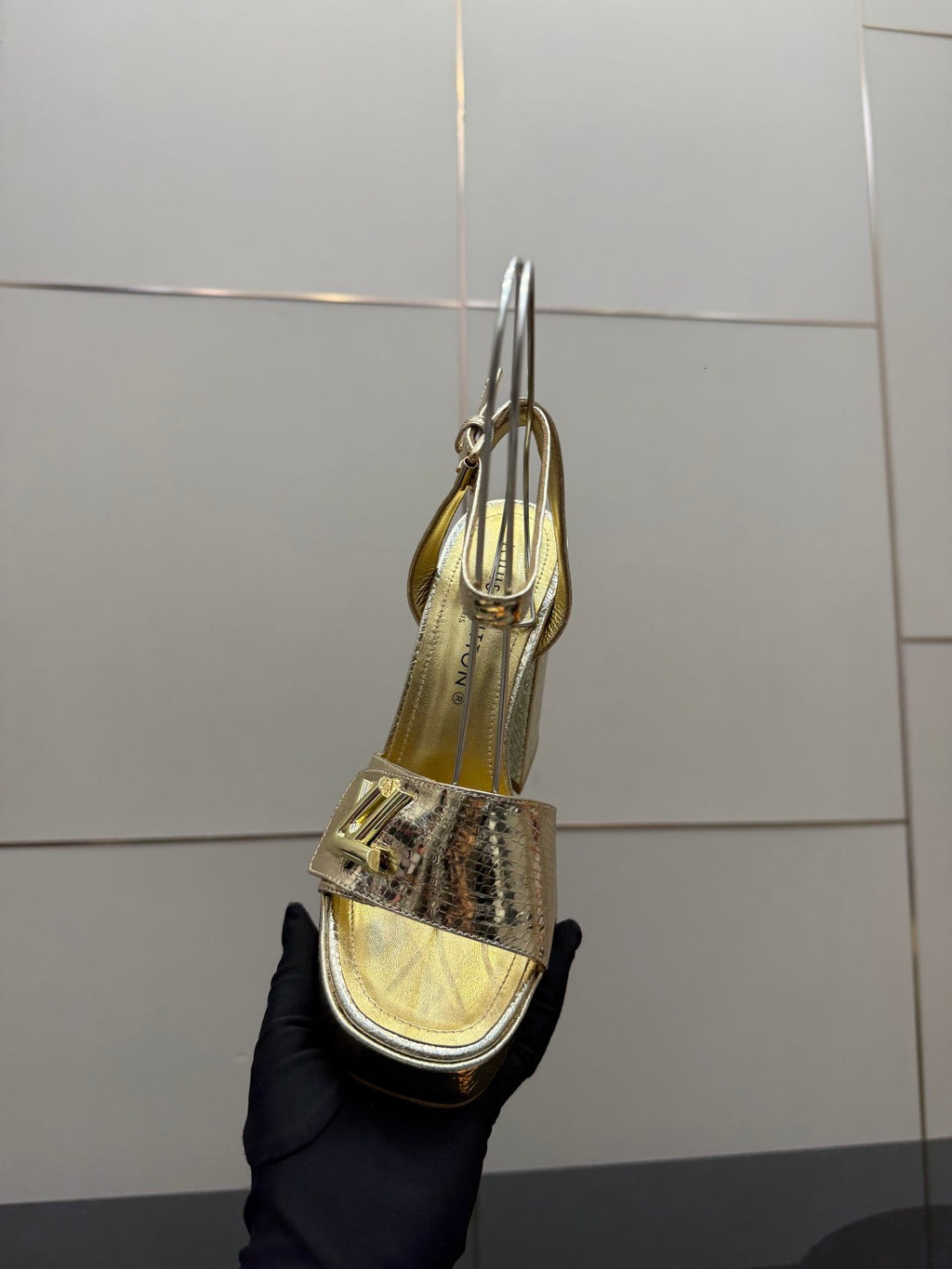 Louis Vuitton ladies metallic heeled sandal, tall heel and ankle strap, back view