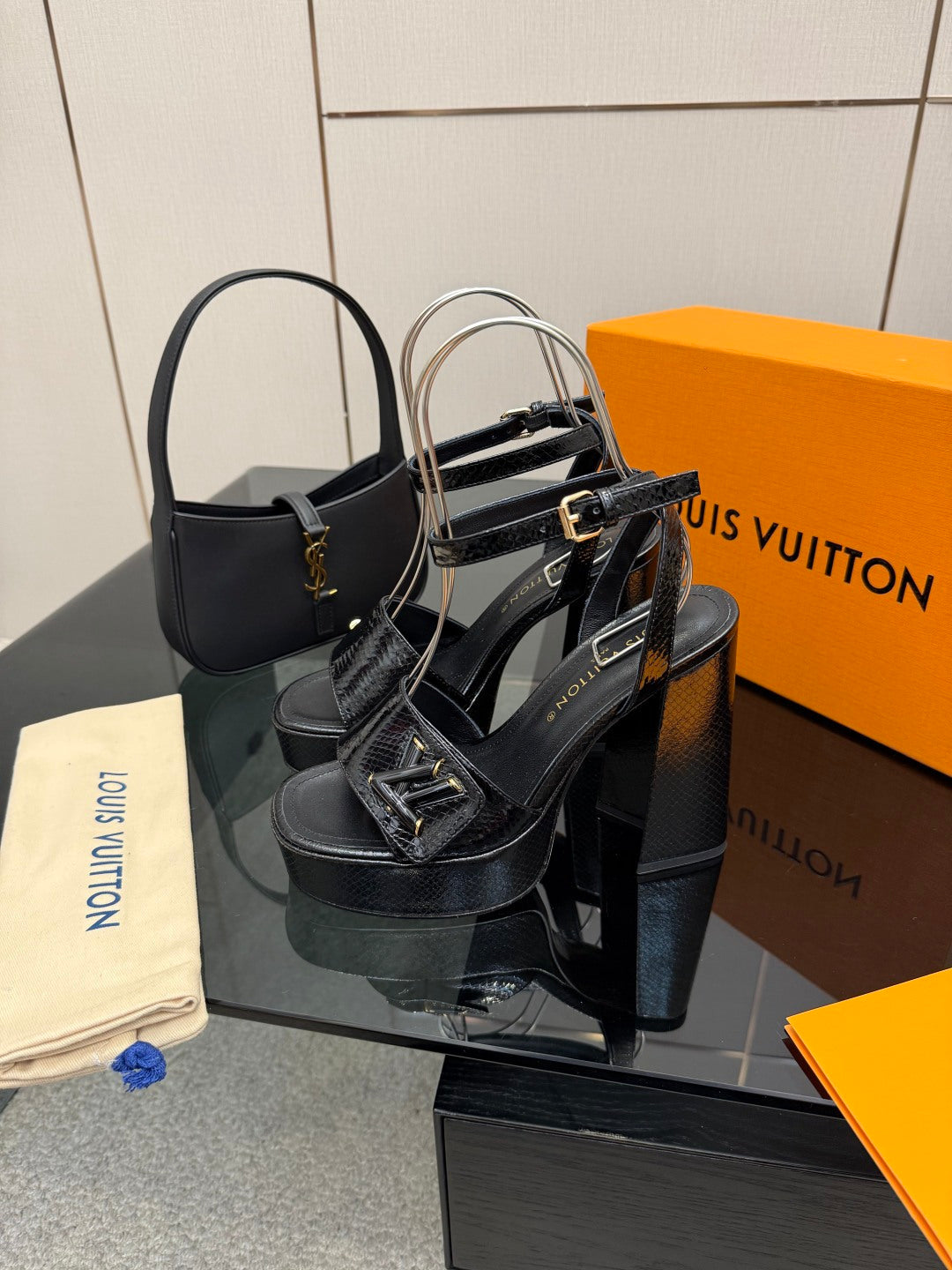 Black heeled sandals with platform sole and crisscross ankle straps