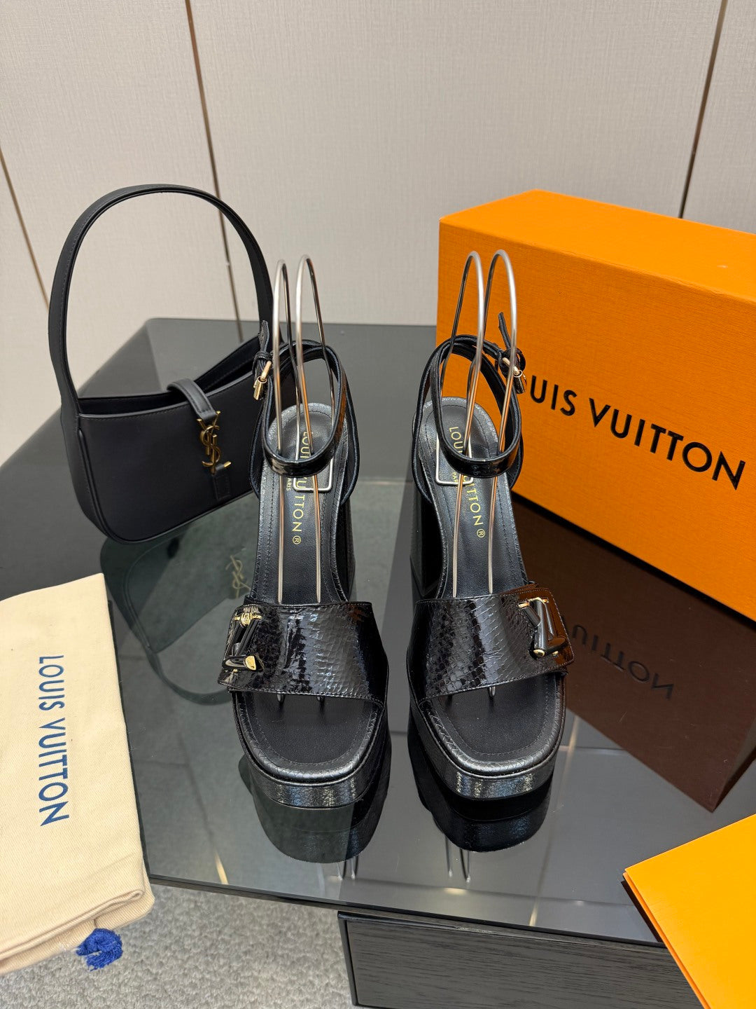 Black platform sandal heels with ankle strap and metallic buckle