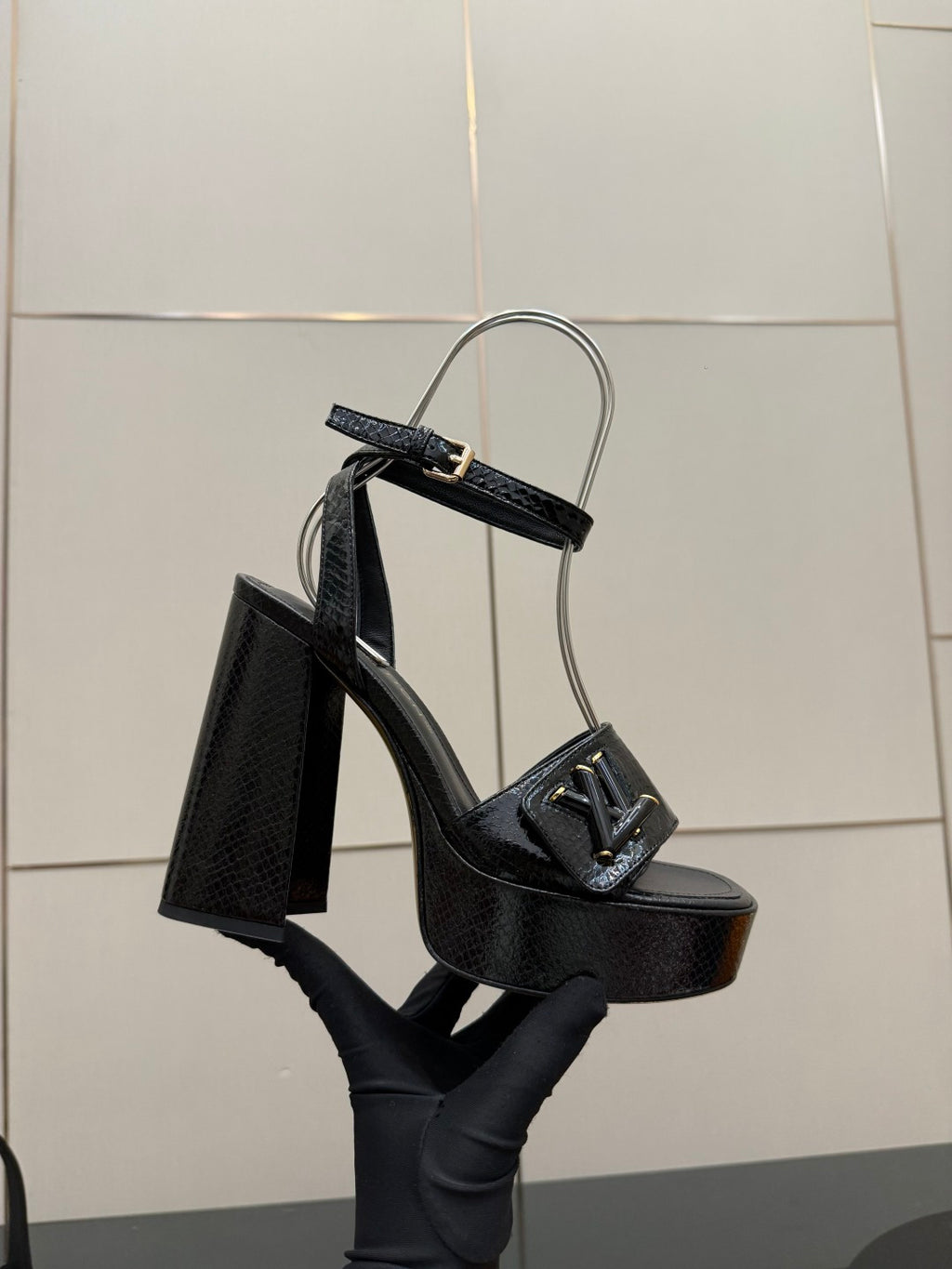 Black high-heel platform sandal with front buckle detail