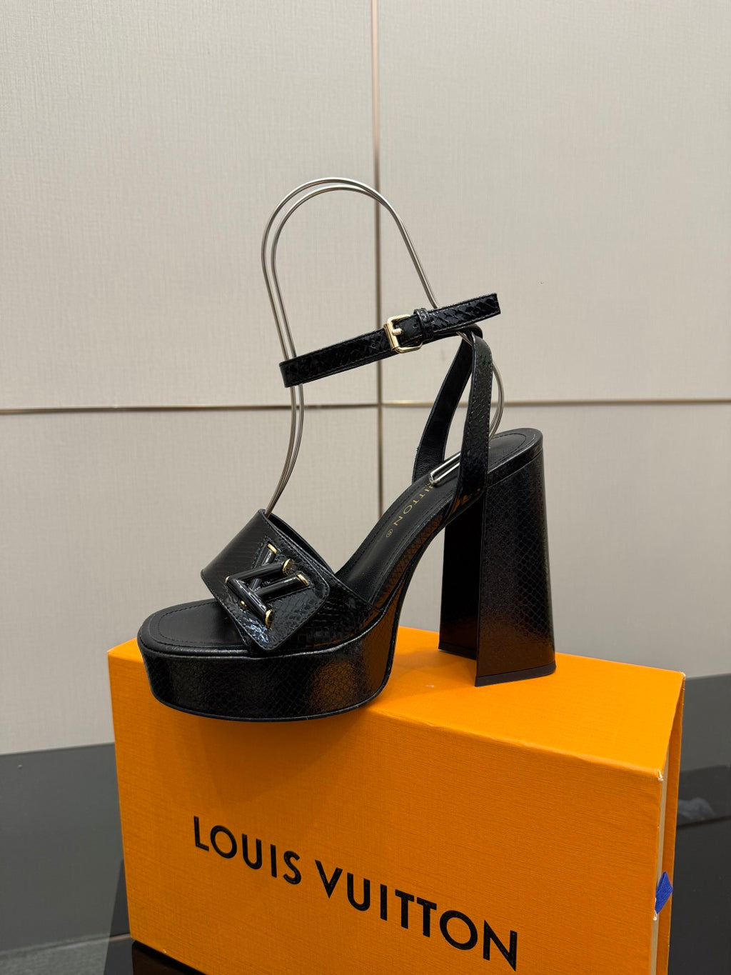 Black platform sandal heel with front strap and metallic buckle