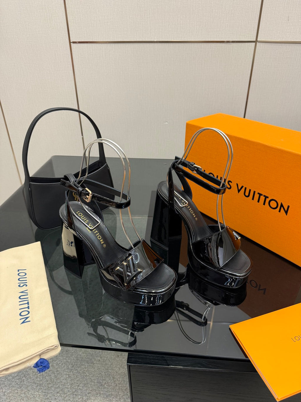 Black high-heel sandals with gold-tone buckles and open toe