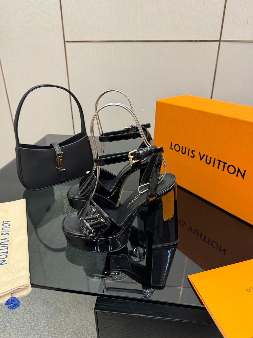 Black platform heeled sandals with ankle straps and gold-tone hardware
