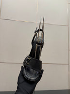 Women’s black platform heeled sandal shown from side/back with ankle strap and buckle.
