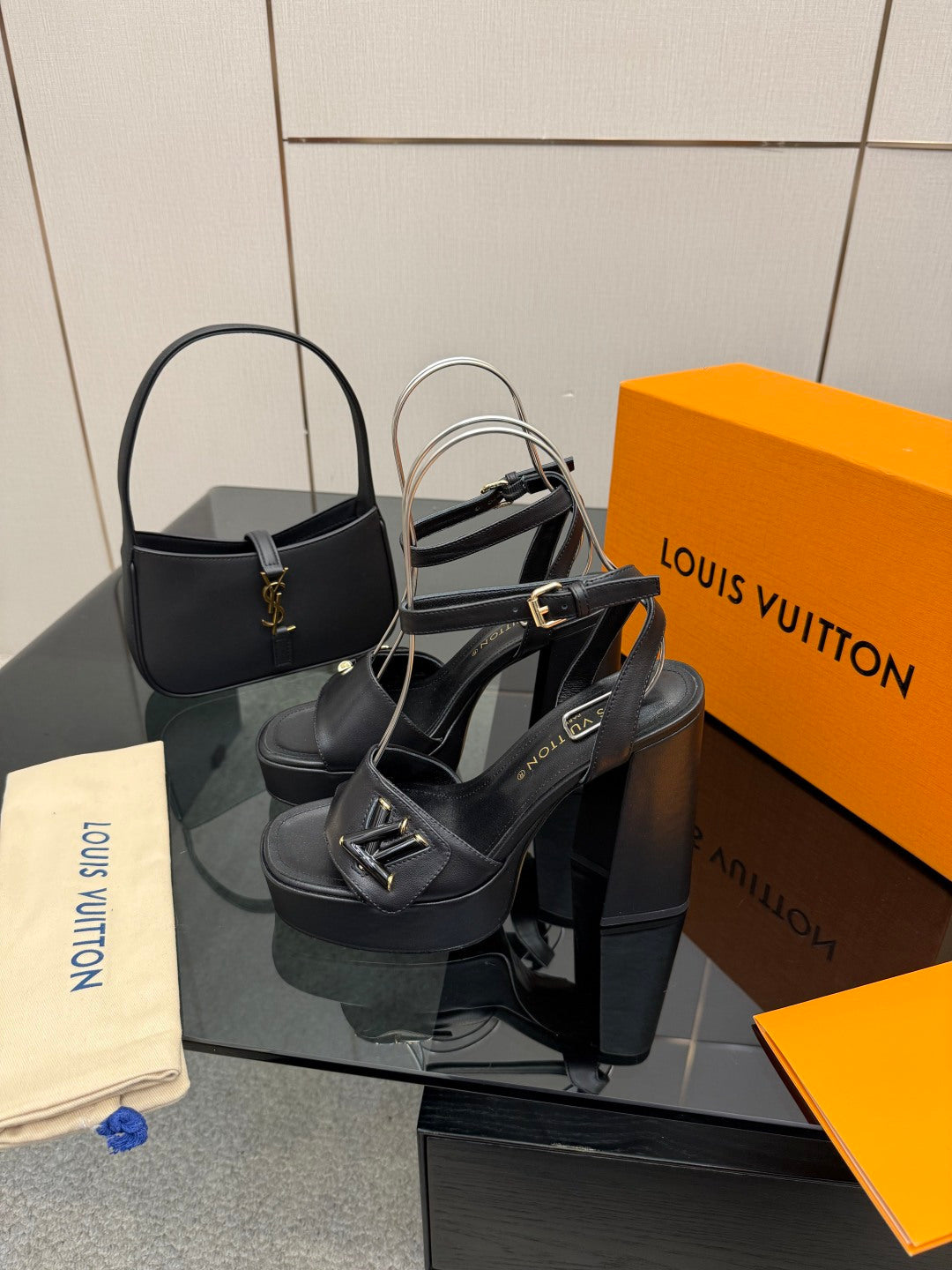 Women’s black platform heeled sandals with slingback strap and V-shaped buckle.