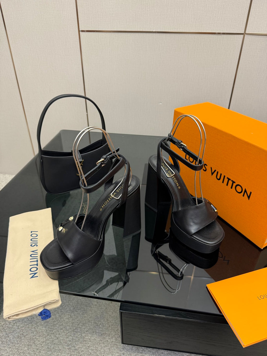 Women’s black platform heeled sandals with ankle strap, thick heel, and V buckle.