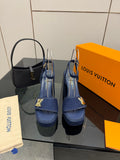 Blue platform heeled sandals with gold logo on ankle strap and thick sole