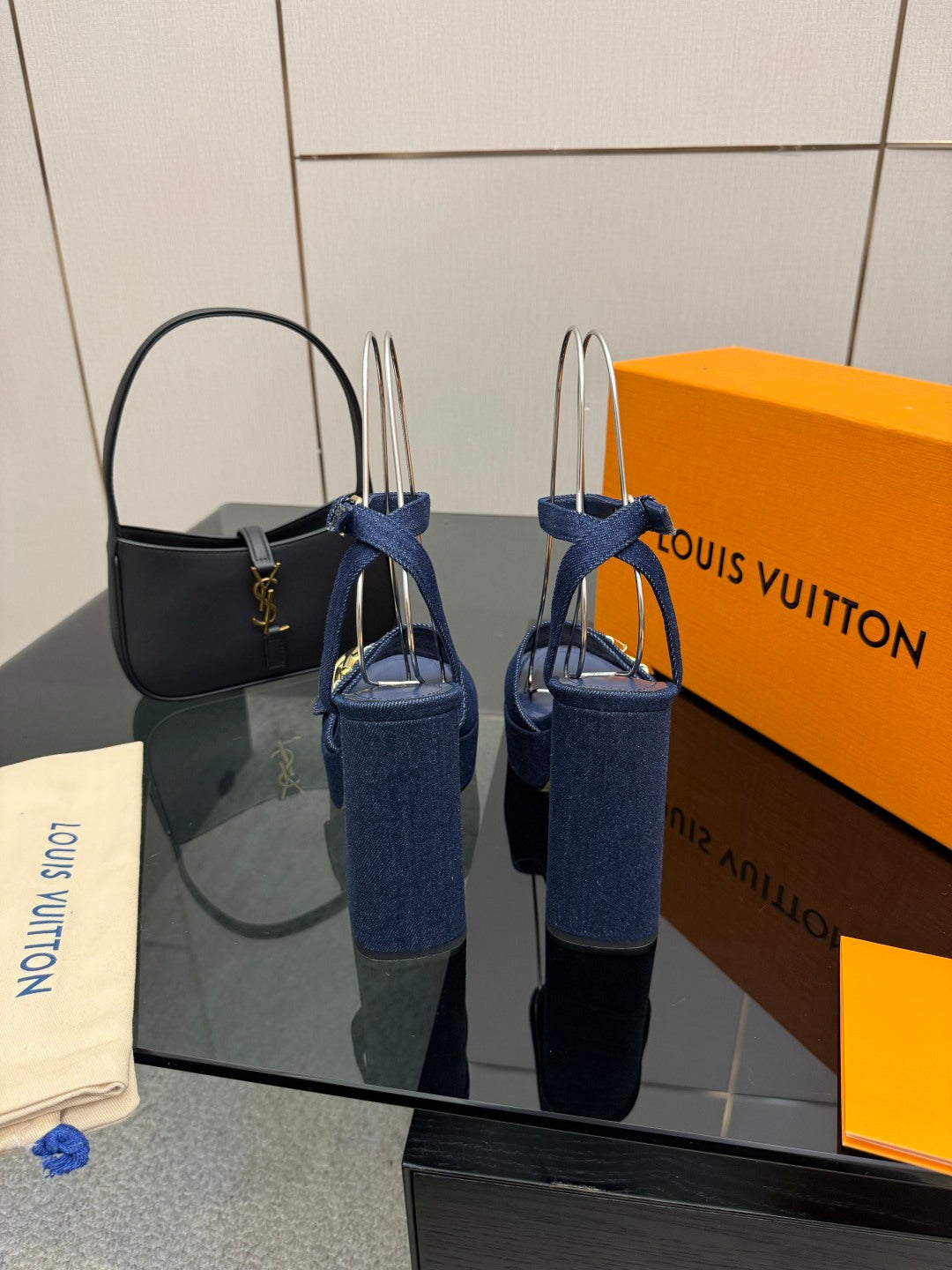 Blue platform heeled sandals with gold logo buckle and slingback strap