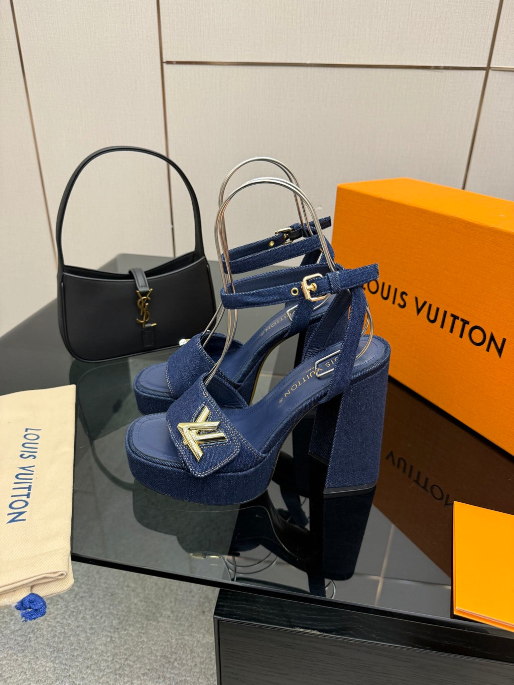 Blue suede platform heeled sandals with gold logo buckle on ankle strap