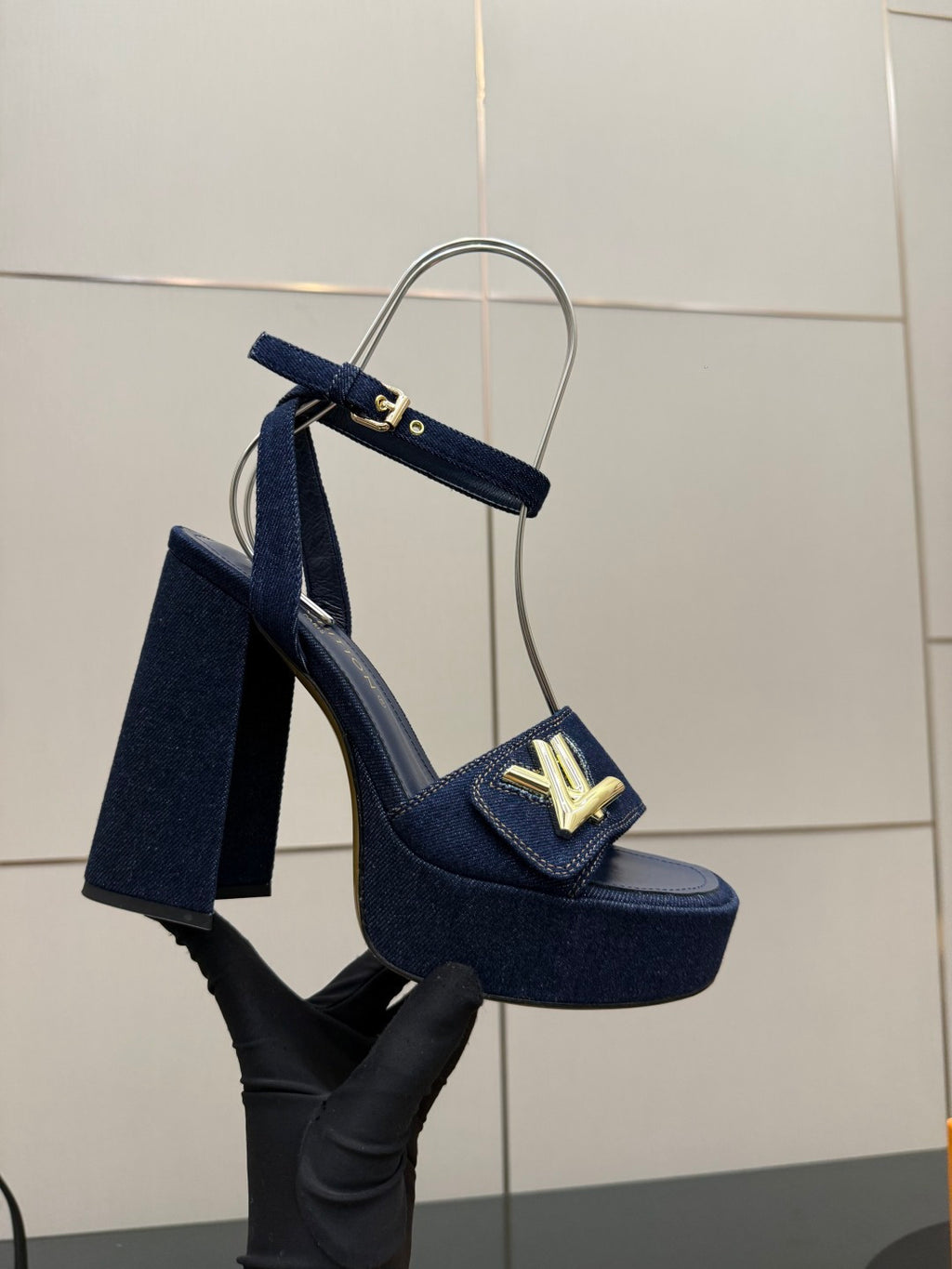 Navy-blue platform heeled sandal with gold logo buckle and thick heel