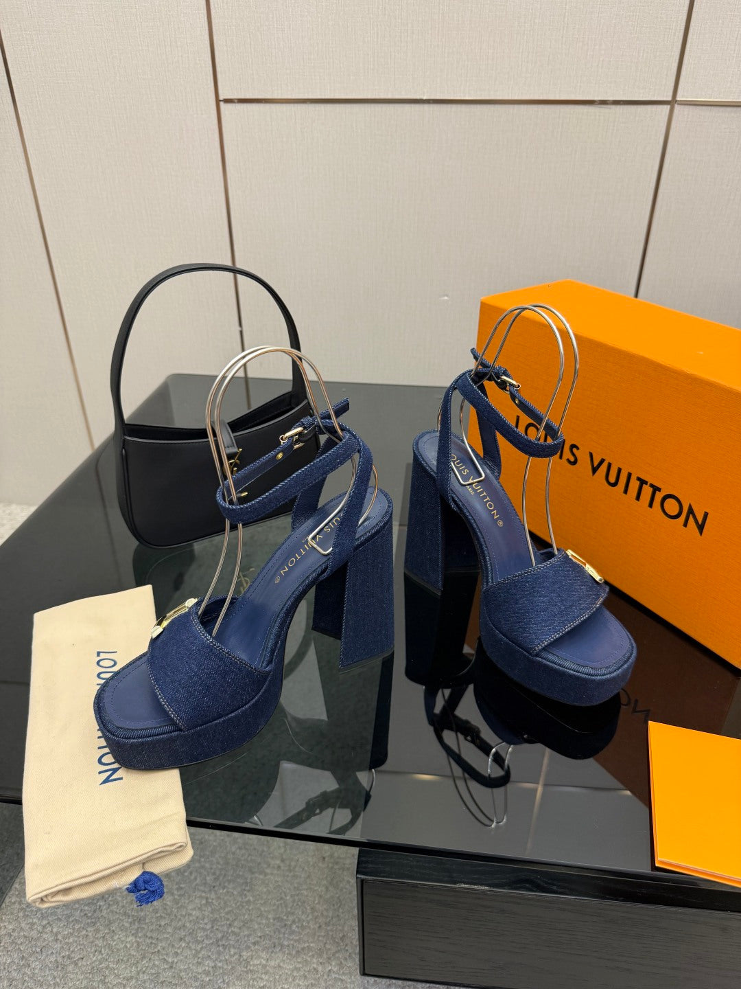 Blue suede platform heeled sandals with thick block heel and gold logo buckle