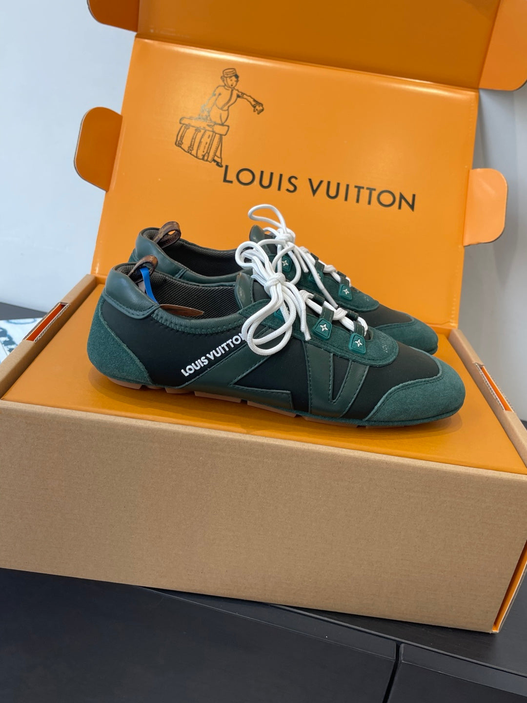 Louis Vuitton unisex sneakers in teal with white laces, side stripe and lace eyelets