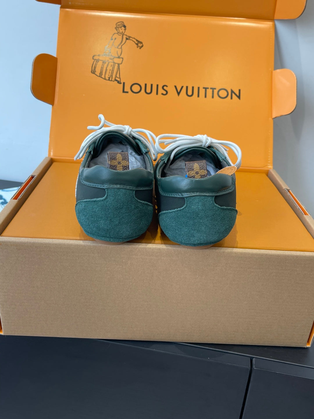 Louis Vuitton unisex sneakers, teal back view with white laces and pull tabs