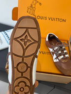 Brown sneaker outsole with patterned emblem, plus side view shoe