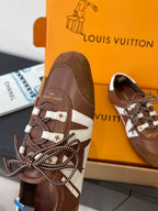 Brown lace-up sneaker with white stripe and beaded laces, toe and heel views