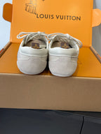 Beige Louis Vuitton unisex sneakers back view in box, showing heel counters and laces