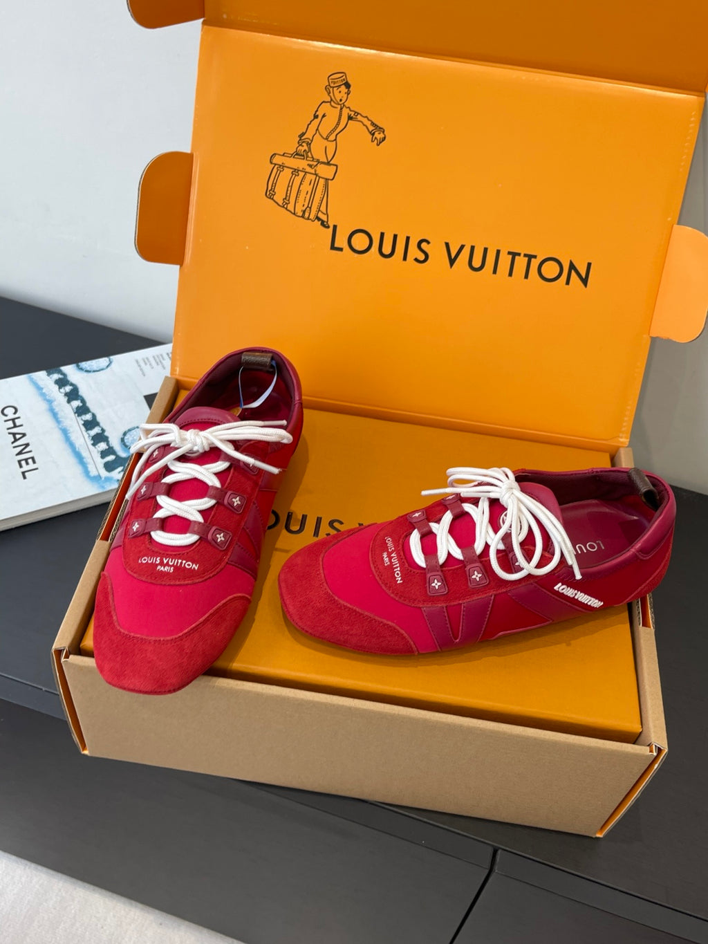 Louis Vuitton unisex red sneakers with white laces, pair in open orange shoebox