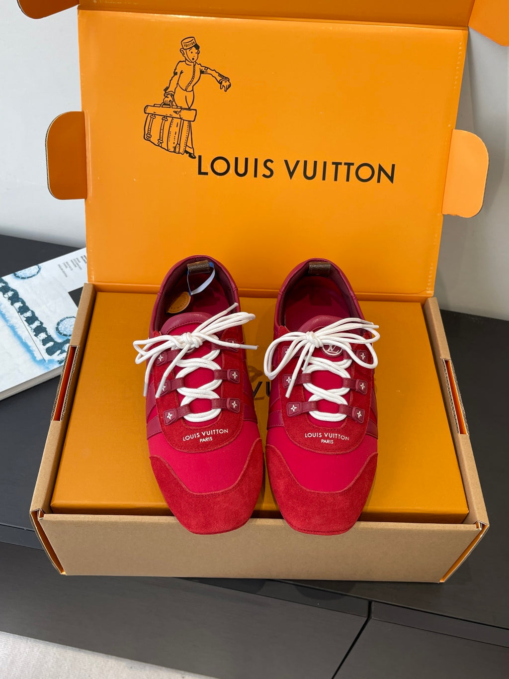 Louis Vuitton unisex red sneakers with white laces, in open orange shoebox