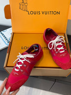Louis Vuitton unisex red sneakers with white laces, shoes laid in open box