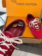 Louis Vuitton unisex red sneakers with white laces, showing interior and toe detail
