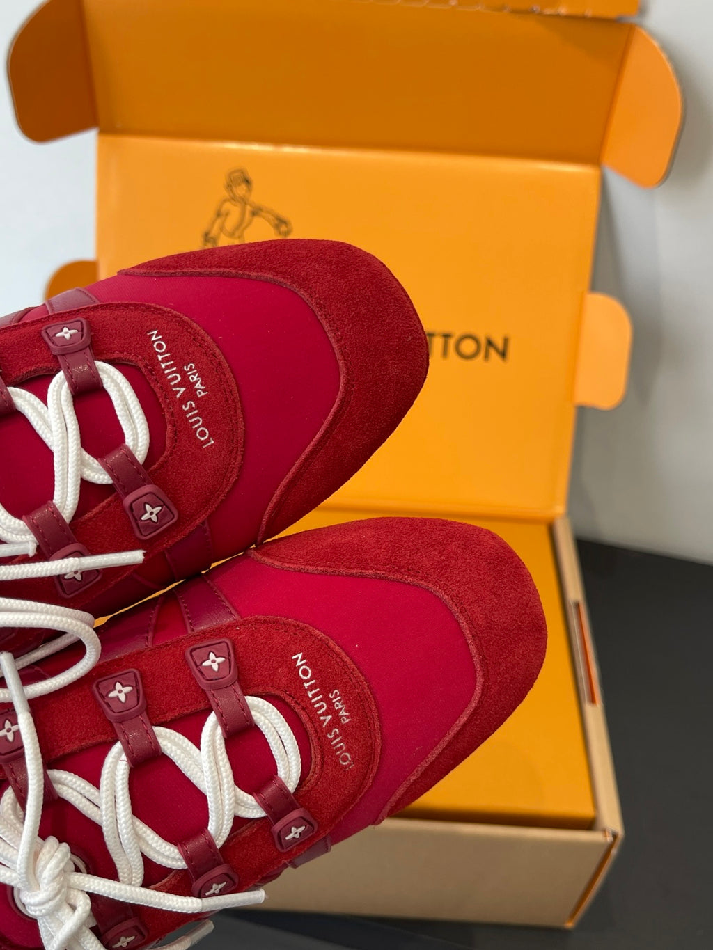 Louis Vuitton unisex red sneakers with white laces, heel and upper close-up in box