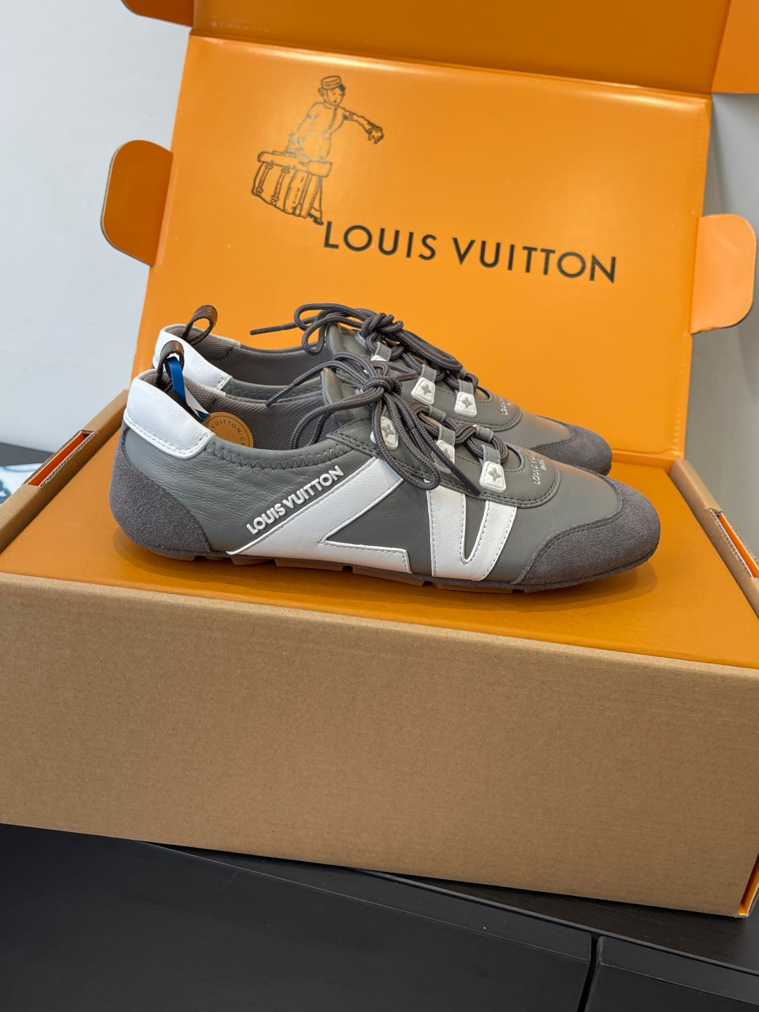 Gray and white lace-up Louis Vuitton sneaker with laces and contrast side panel
