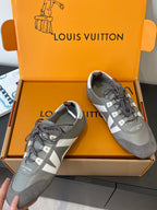 Pair of gray and white Louis Vuitton lace-up sneakers in box, side and front views