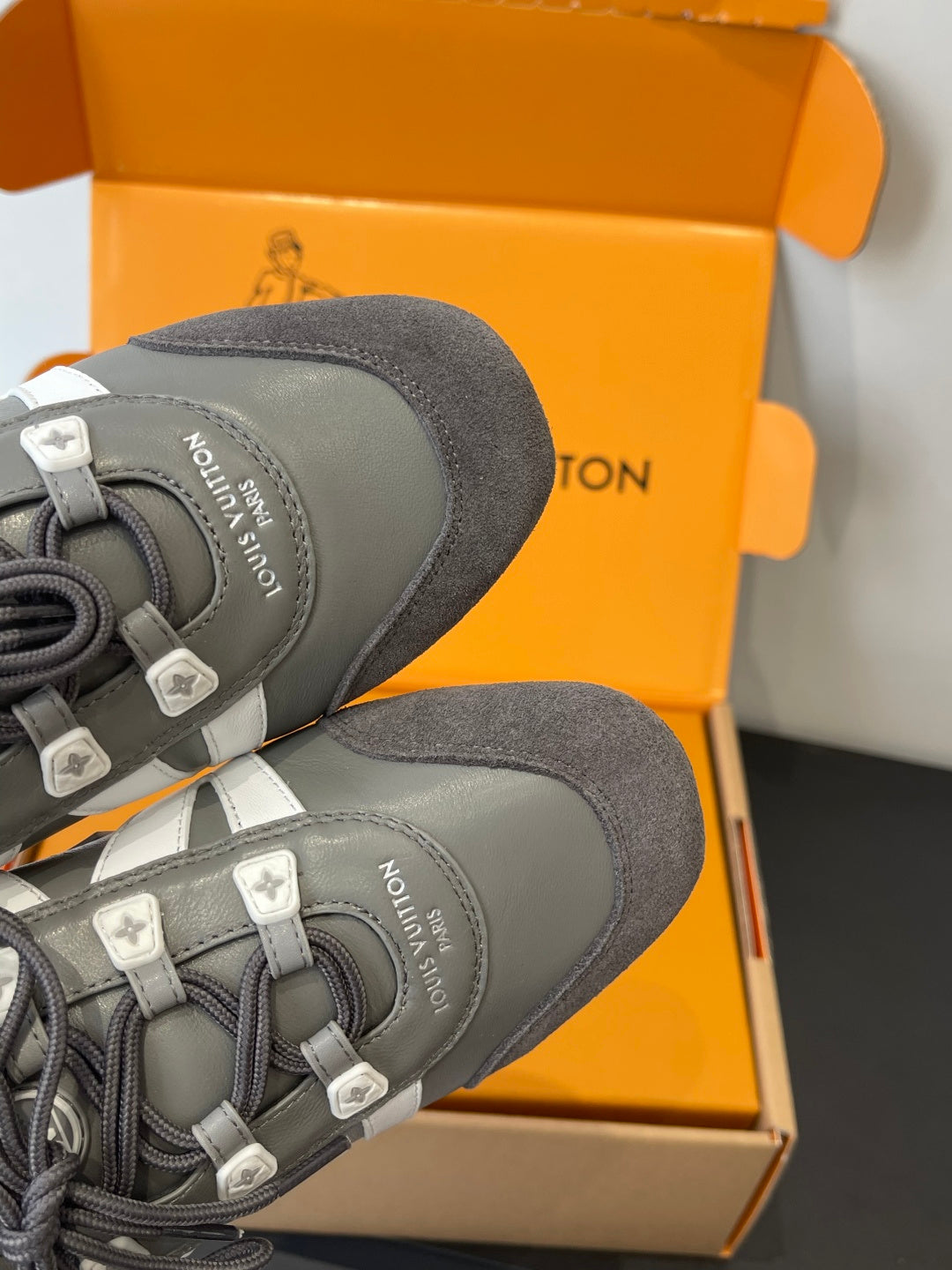 Gray Louis Vuitton sneakers, close-up of heel and laces with cushioned collar