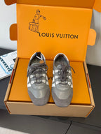 Gray and white lace-up Louis Vuitton sneakers, front view with signature side stripe