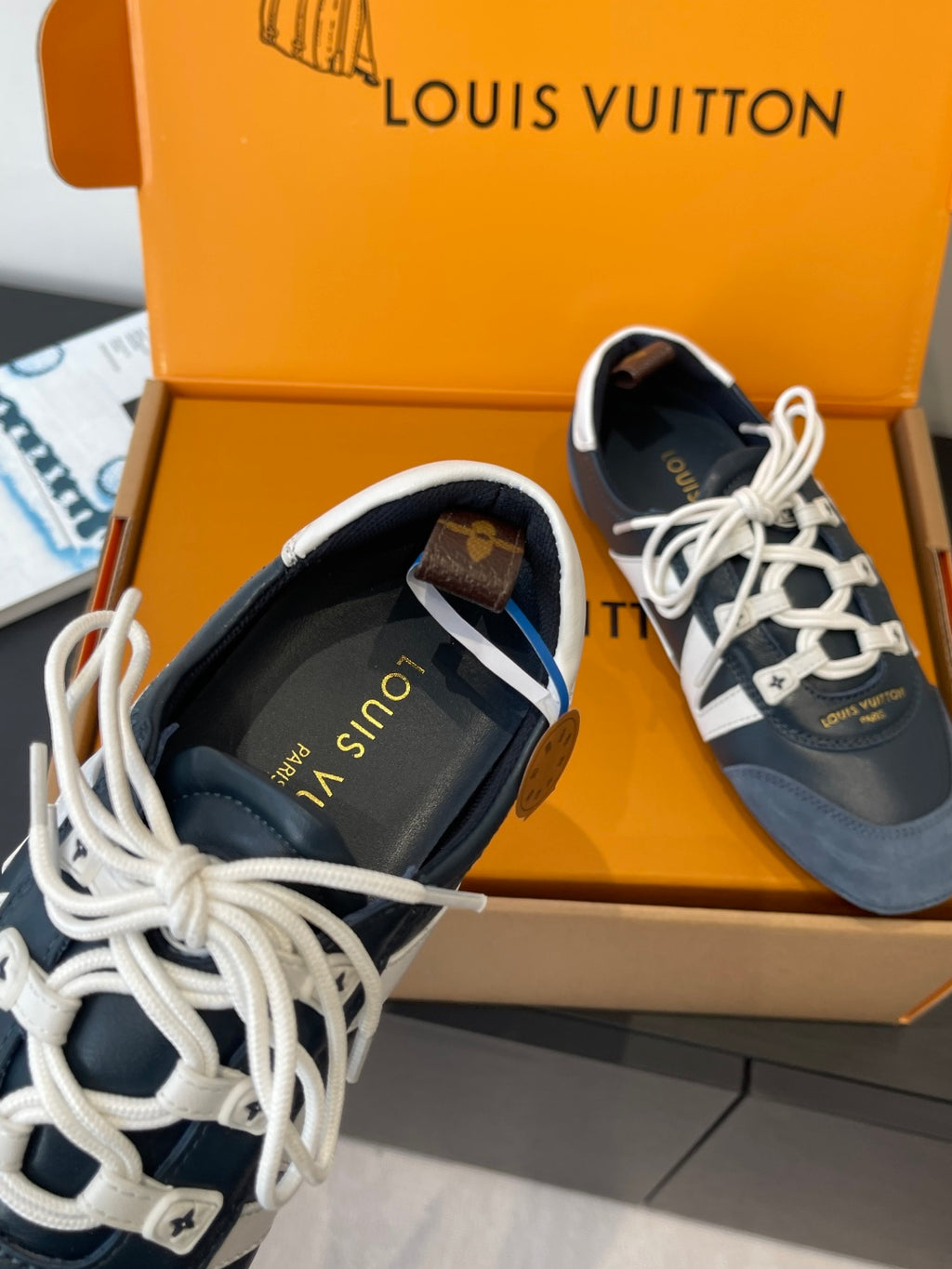 Louis Vuitton unisex sneakers toe view, white laces and dark blue suede with logo print