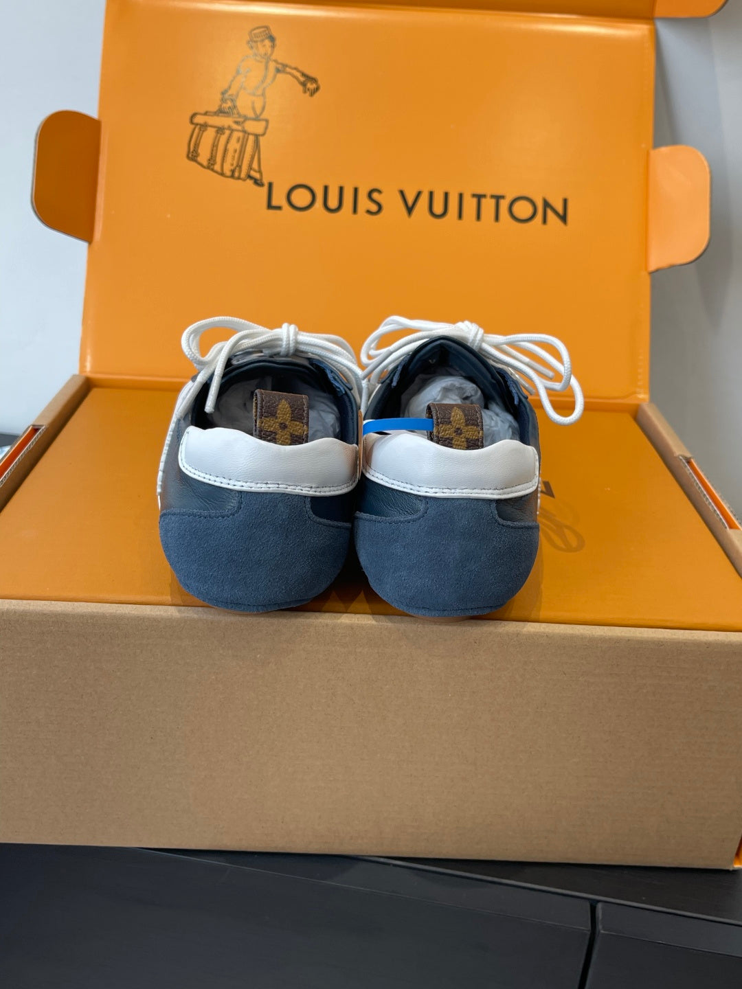 Louis Vuitton unisex luxury shoes, rear view in blue suede with white laces