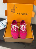 Unisex sneakers in bright pink with white lace-up front, shown in a box