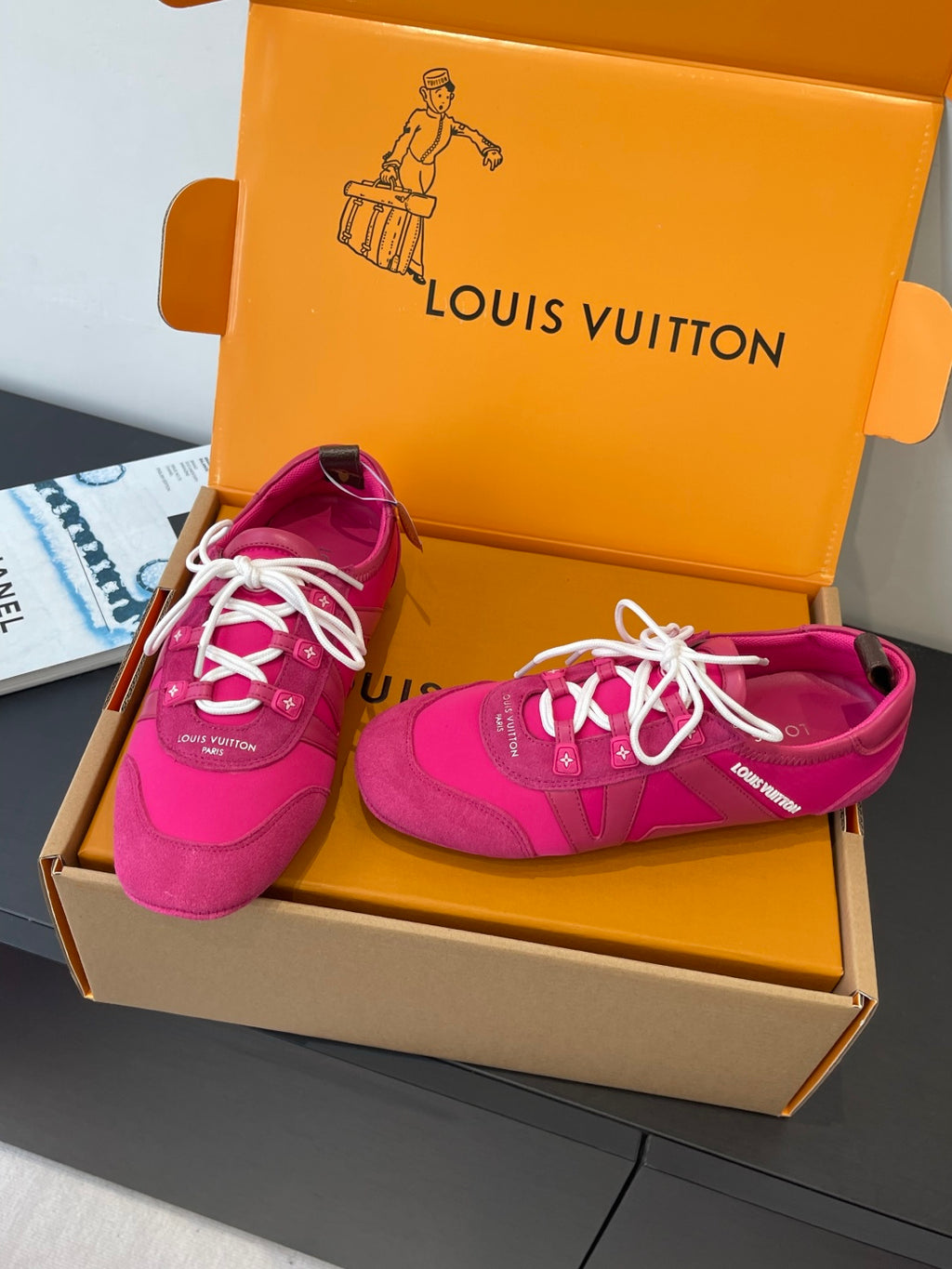 Unisex bright pink sneakers with white laces, side stripes, and low sole