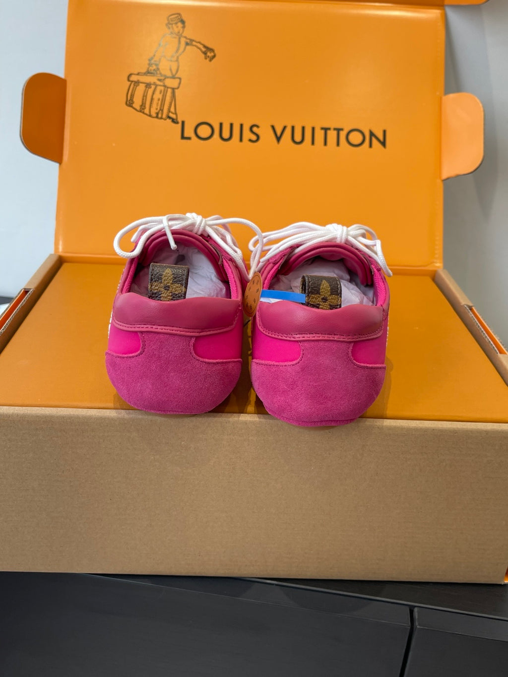 Unisex pink sneakers back view with white laces and cushioned heel