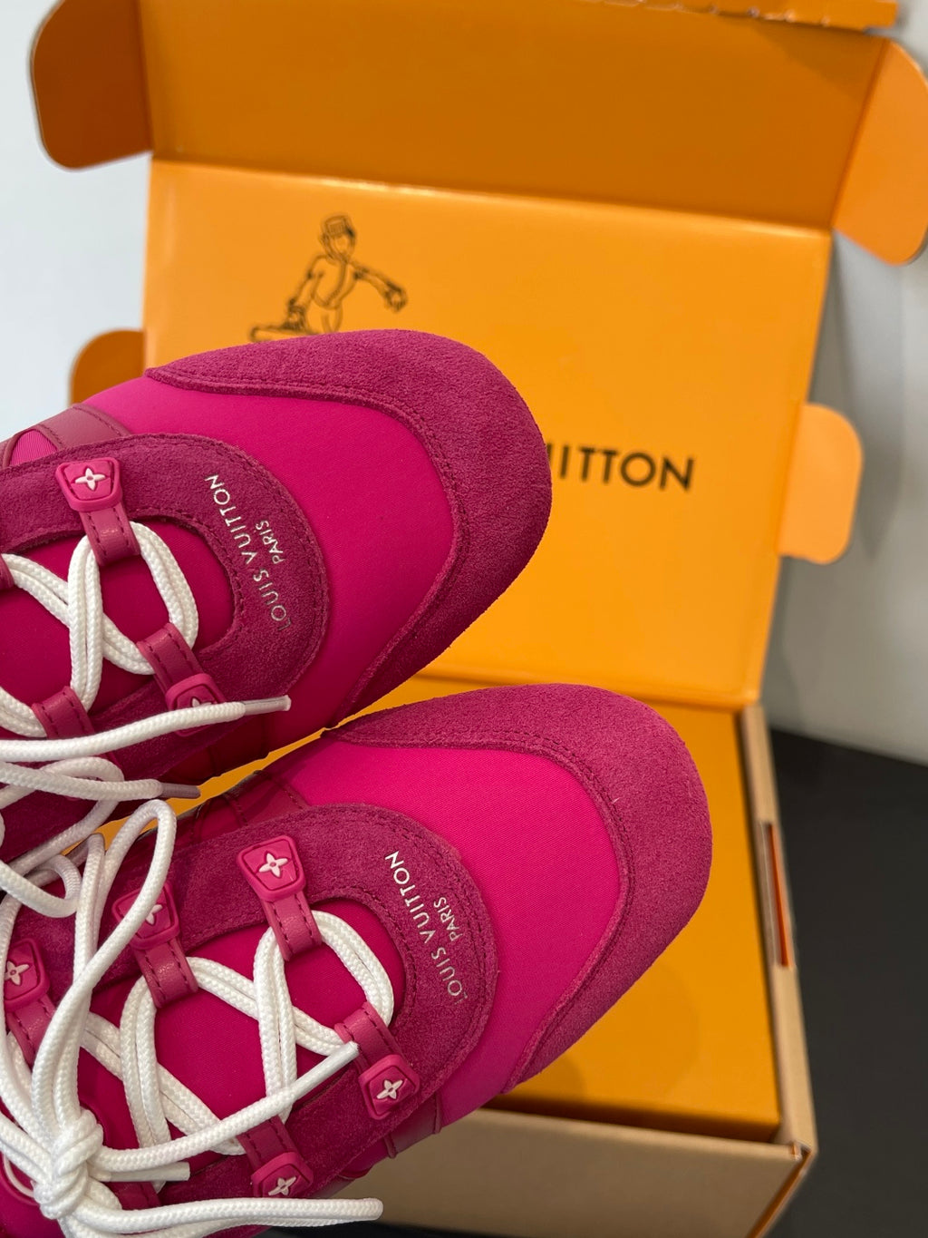 Unisex pink sneakers side view with white laces and stitched details
