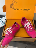 Pair of bright pink unisex sneakers with white laces and mesh lining